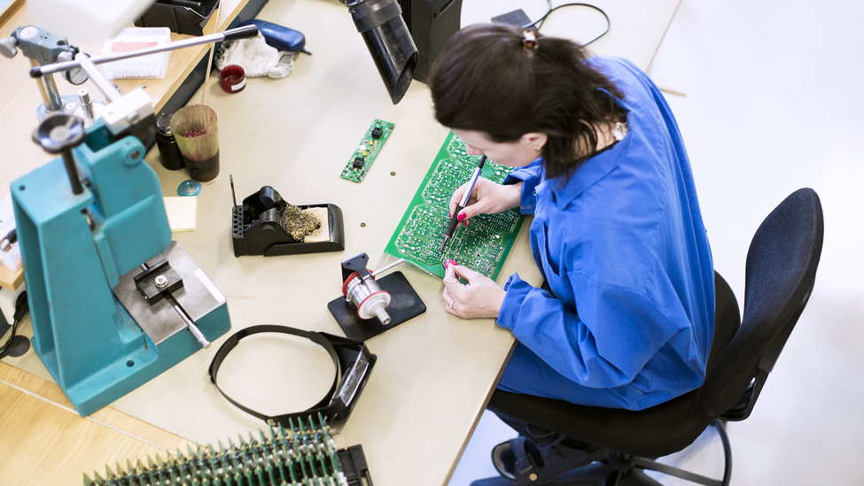 Person looking at counterfeit electronic parts.